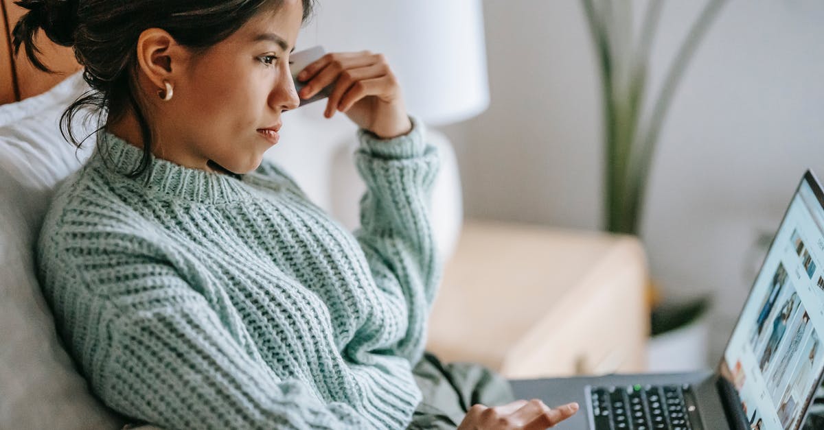 How to successfully cross a river without using money - Side view of crop concentrated young ethnic female using touchpad of netbook and shopping online