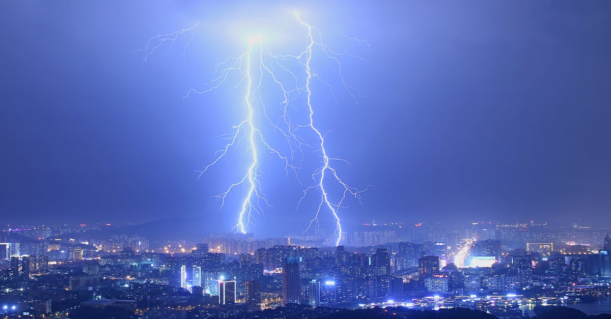How to summon lightning bolt at normal (and not charged) creepers only? - Breathtaking thunderstorm with lightning bolts over modern illuminated city at night with purple sky