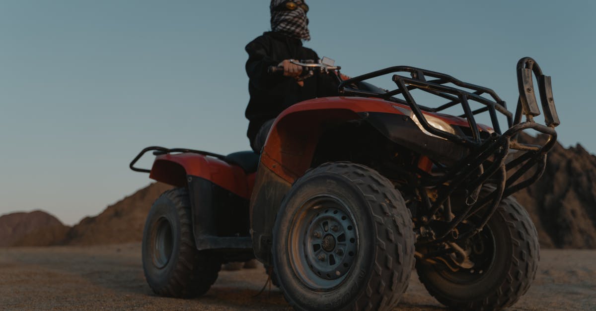 How to tag all snowballs that aren't riding another entity? - Low Angle Shot of a Man Riding an ATV on the Desert