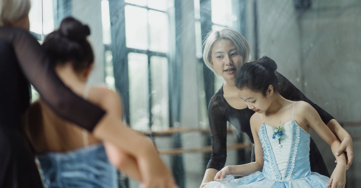 How to teach my child my profession in the guild 2? - Professional ethnic ballerina teaching pupil ballet in dance room of school while looking at reflection in mirror