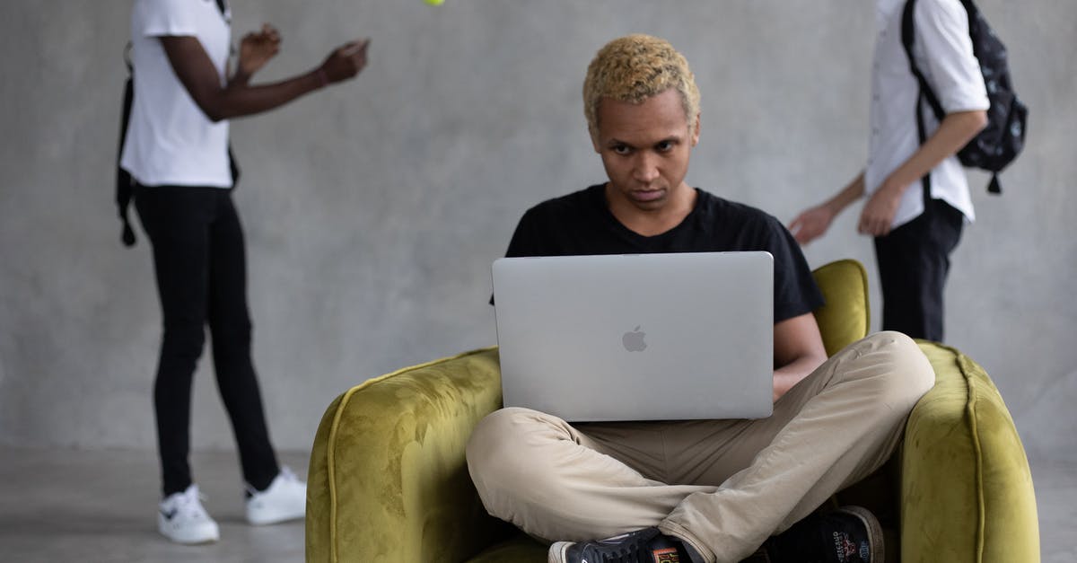 How to teleport a player who activates a command block without using @p? - Concentrated African American learner sitting in chair and browsing netbook for studies against classmates playing with ball