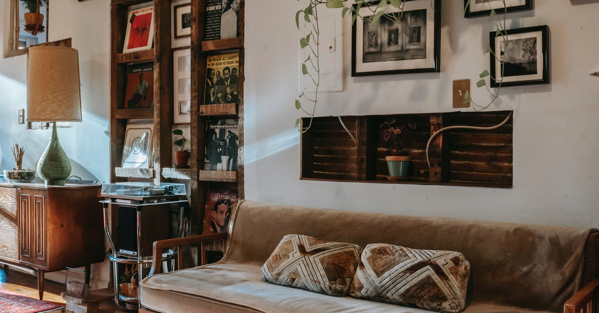 How to /tell a Player an NBT property of a item on 1.12.2? - Interior of stylish living room with comfortable couch placed near shelf with collection of vintage vinyl records and wooden cabinet decorated with classic table lamp