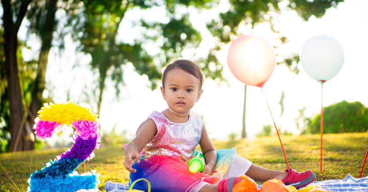 How to tell the number of wins with any given civ? - Girl in Pink Dress Sitting on Blue and Pink Textile Surrounded by Balloons