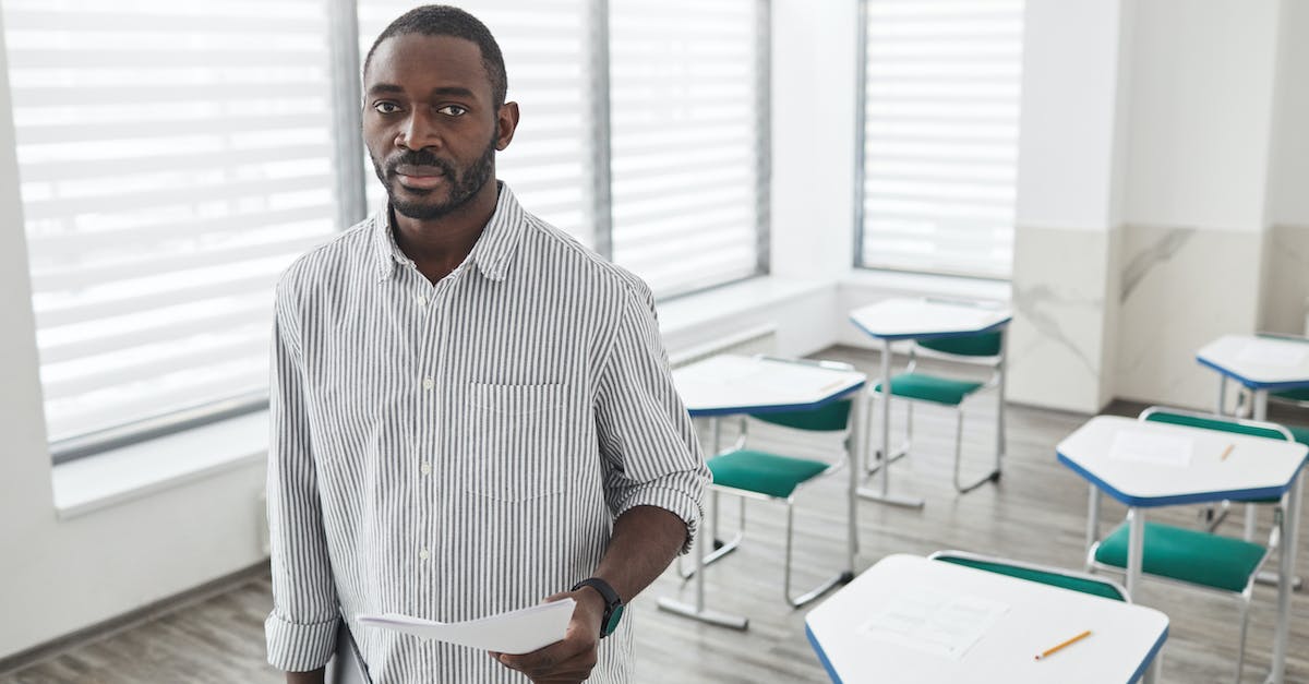 How to test for people standing on a specific block? - A Man Holding Test Papers Inside the Classroom How to test for people standing on a specific block? - A Man Holding Test Papers Inside the Classroom