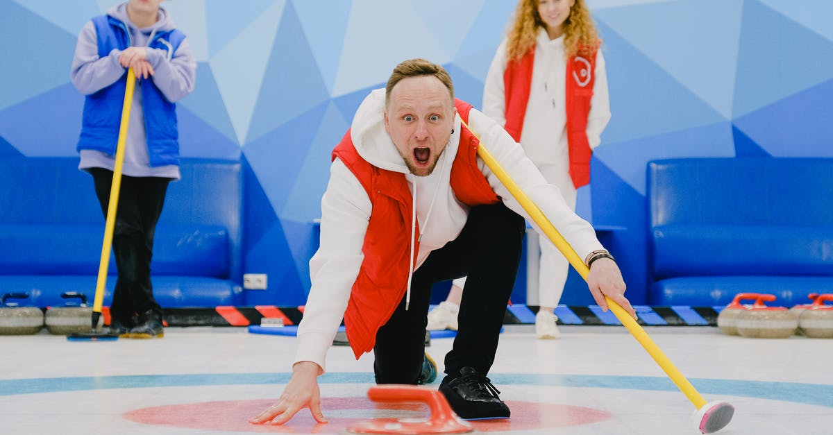 How to throw the crate in Inside on iOS? - Excited sportsman with open mouth in activewear standing on knee with broom and throwing stone with red handle while playing curling on ice rink