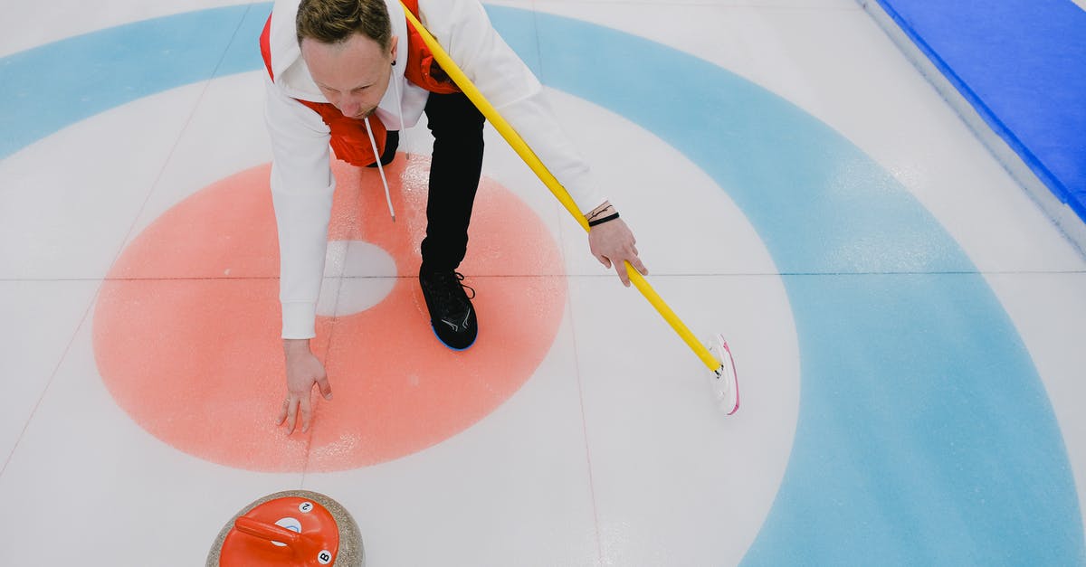 How to throw the crate in Inside on iOS? - From above of concentrated sportsman in activewear throwing stone during curling competition on ice rink in daytime
