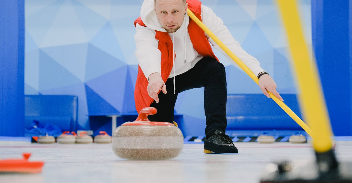 How to throw the crate in Inside on iOS? - Determined sportsman in sportswear with special broom in hand throwing granite curling stone sliding on ice sheet while playing game