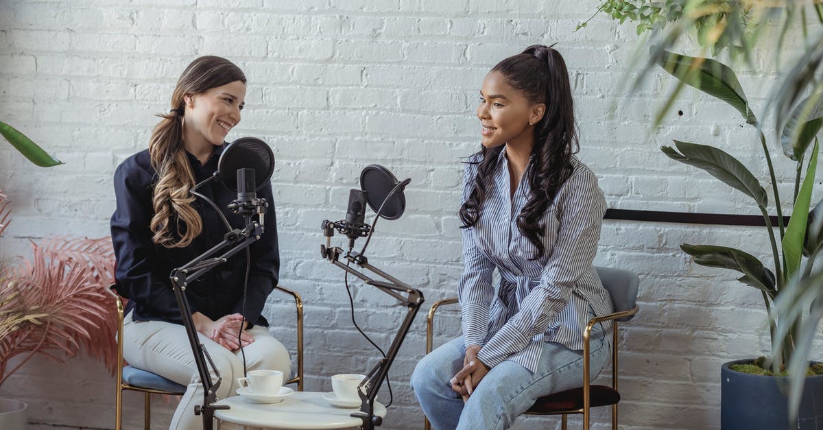 How to trigger voice lines? - Diverse women communicating while recording voice in studio with white brick walls in daytime How to trigger voice lines? - Diverse women communicating while recording voice in studio with white brick walls in daytime