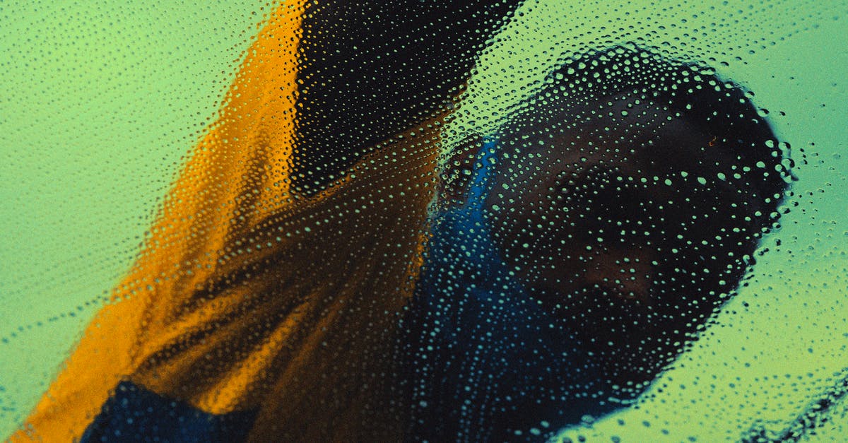 How to turn a salty water into normal, drinkable water? - Unrecognizable black man washing windshield in daytime