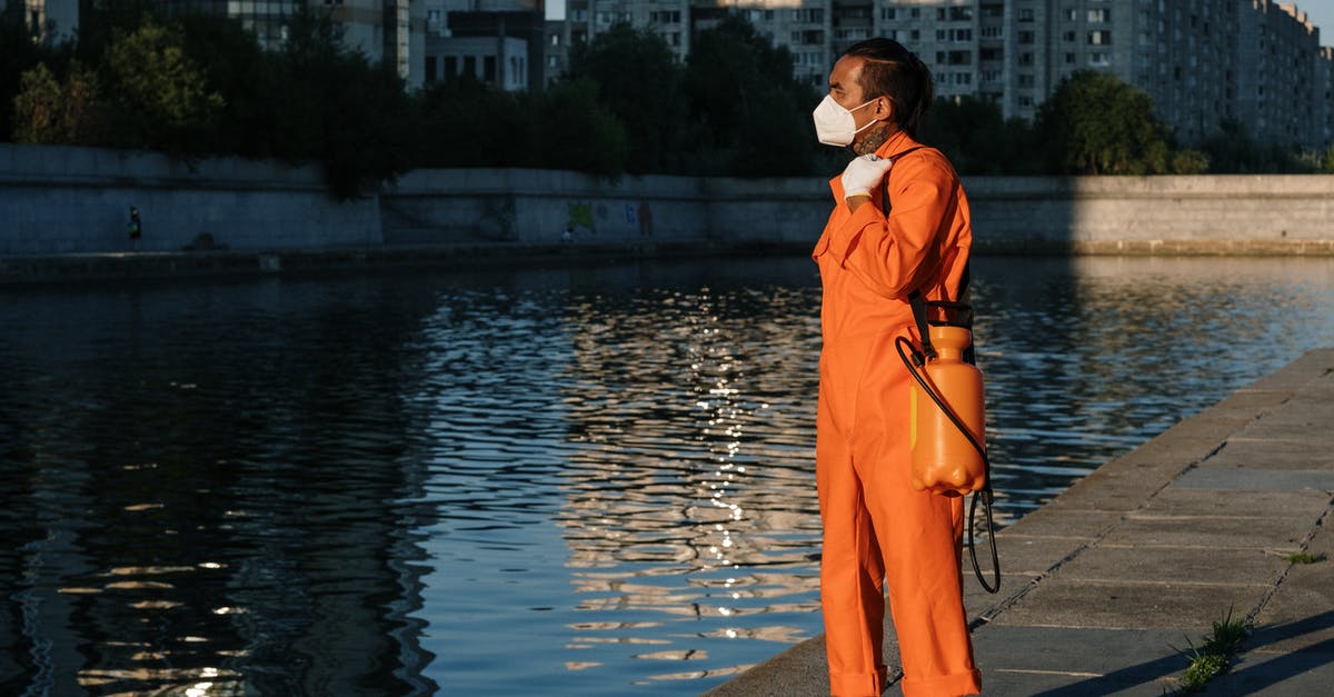 How to turn a salty water into normal, drinkable water? - A Man in Orange Jumpsuit Standing Near Body of Water