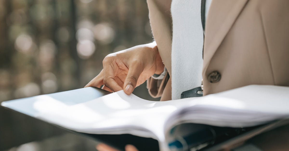 How to turn cheats on or off - Crop faceless female entrepreneur in stylish jacket reading important documents in black folder How to turn cheats on or off - Crop faceless female entrepreneur in stylish jacket reading important documents in black folder