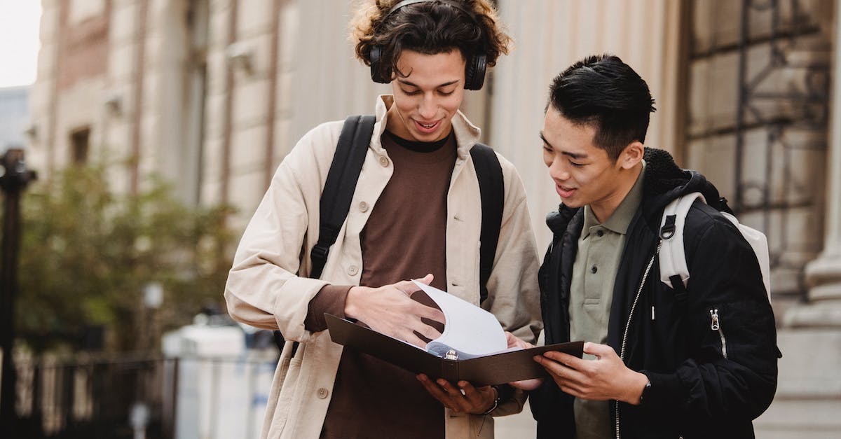How to turn off a .cfg file? - Smiling multiracial classmates turning pages of file on folder with homework task near university How to turn off a .cfg file? - Smiling multiracial classmates turning pages of file on folder with homework task near university
