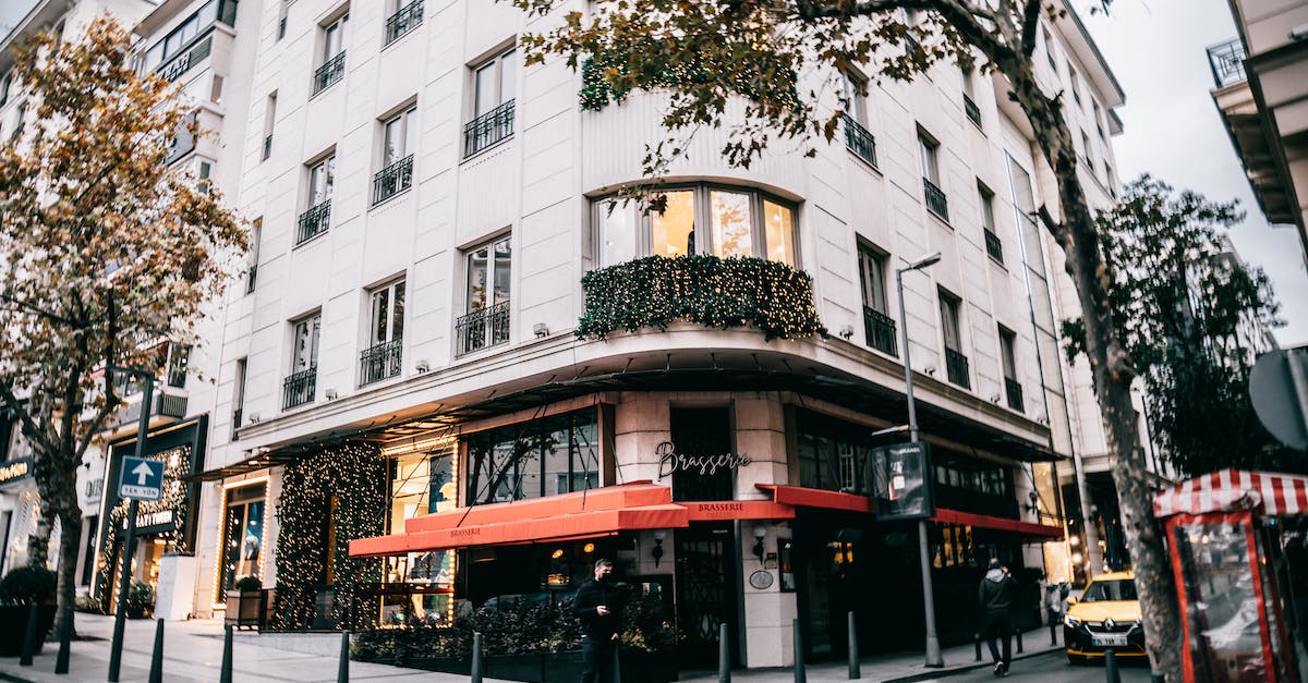 How to use a command block to welcome new players on a server in Minecraft? - Exterior of modern white building corner with commerce organization located in urban city district on clear autumn day