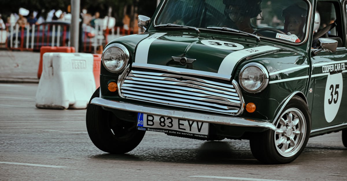 How to use a switch to turn a timer on without the timer turning itself off? - Black retro car driving fast in turn on asphalt roadway taking part in urban races