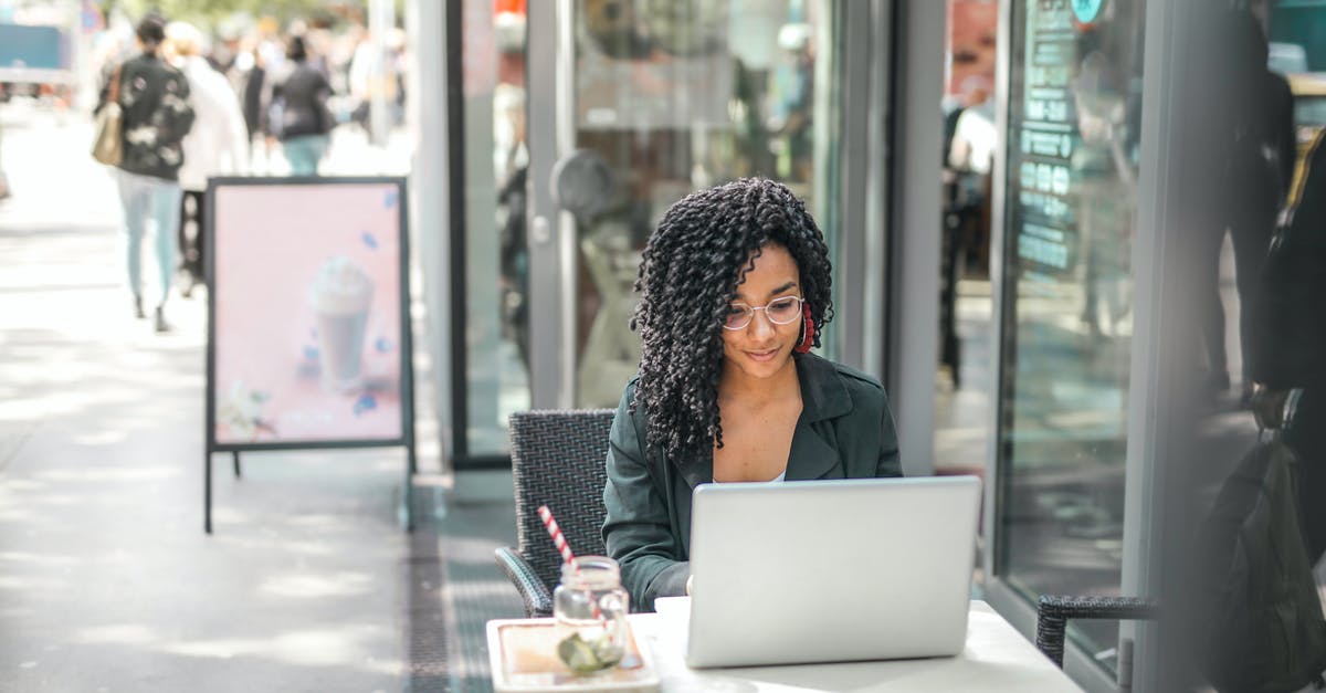How to Use F3 without Fn [duplicate] - High angle of pensive African American female freelancer in glasses and casual clothes focusing on screen and interacting with netbook while sitting at table with glass of yummy drink on cafe terrace in sunny day