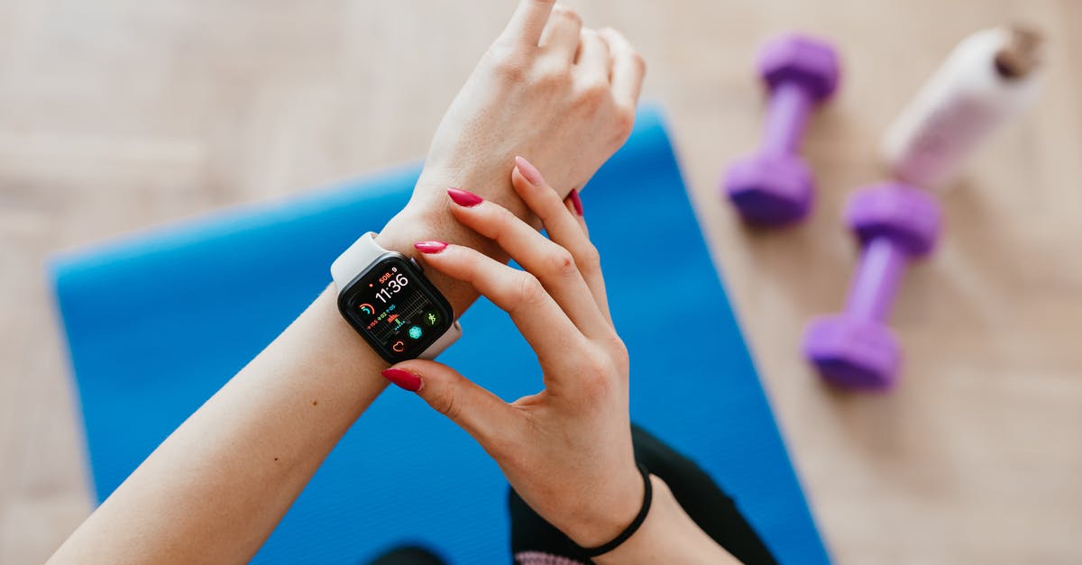 How to use the Active Life Mat with a Wii Mini? - Anonymous sportswoman checking smart watch and sitting on mat