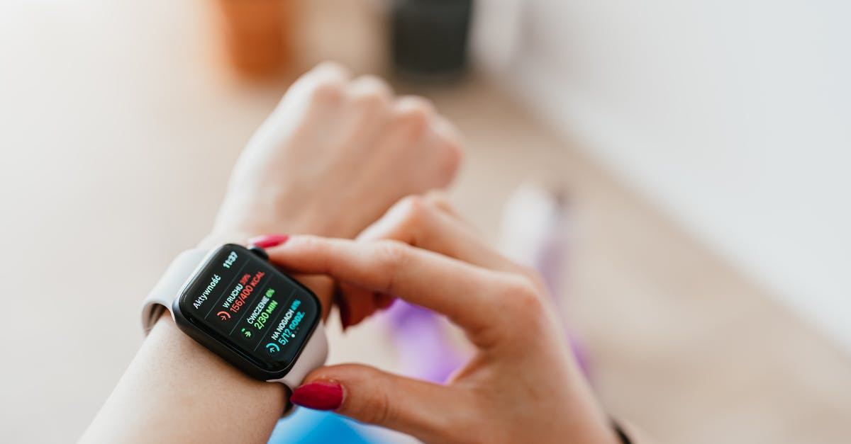 How to use the Active Life Mat with a Wii Mini? - Faceless woman checking smartwatch and sitting on mat