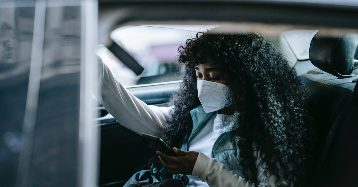 How to use the minecraft 1.9 "Passengers" tag? - Focused black woman in medical mask browsing smartphone in car
