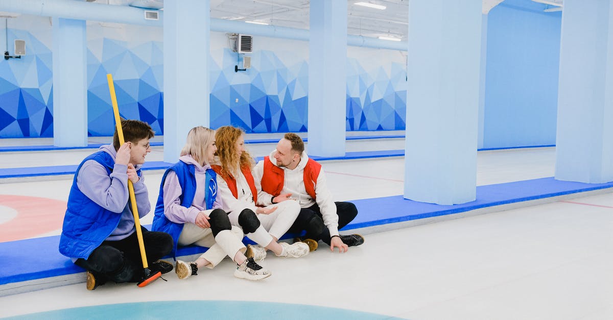 How to use the /testfor command to detect what a player says in chat [duplicate] - Sportsmen in red and blue waistcoats chatting on floor of spacious curling arena