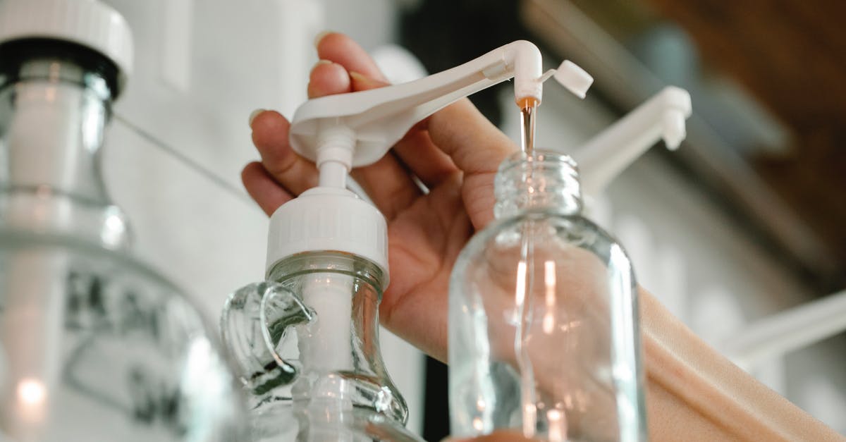 How to utilize Dogmeat's fetch? - Crop unrecognizable person pushing and pouring soap from dispenser to plastic bottle