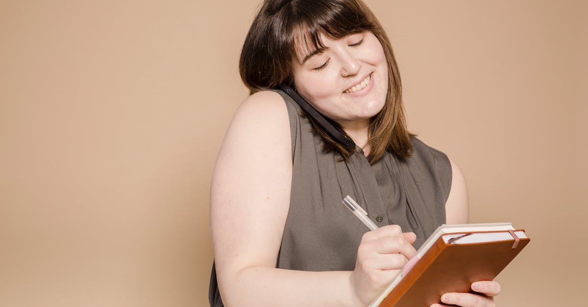 How to write to common chat in Heroes of the storm? - Cheerful Asian woman writing in notebook while having phone call How to write to common chat in Heroes of the storm? - Cheerful Asian woman writing in notebook while having phone call