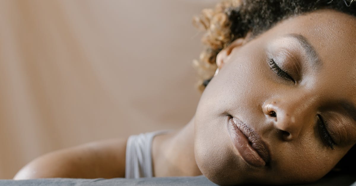 How will I sleep? - Woman in White Tank Top Lying on Gray Textile