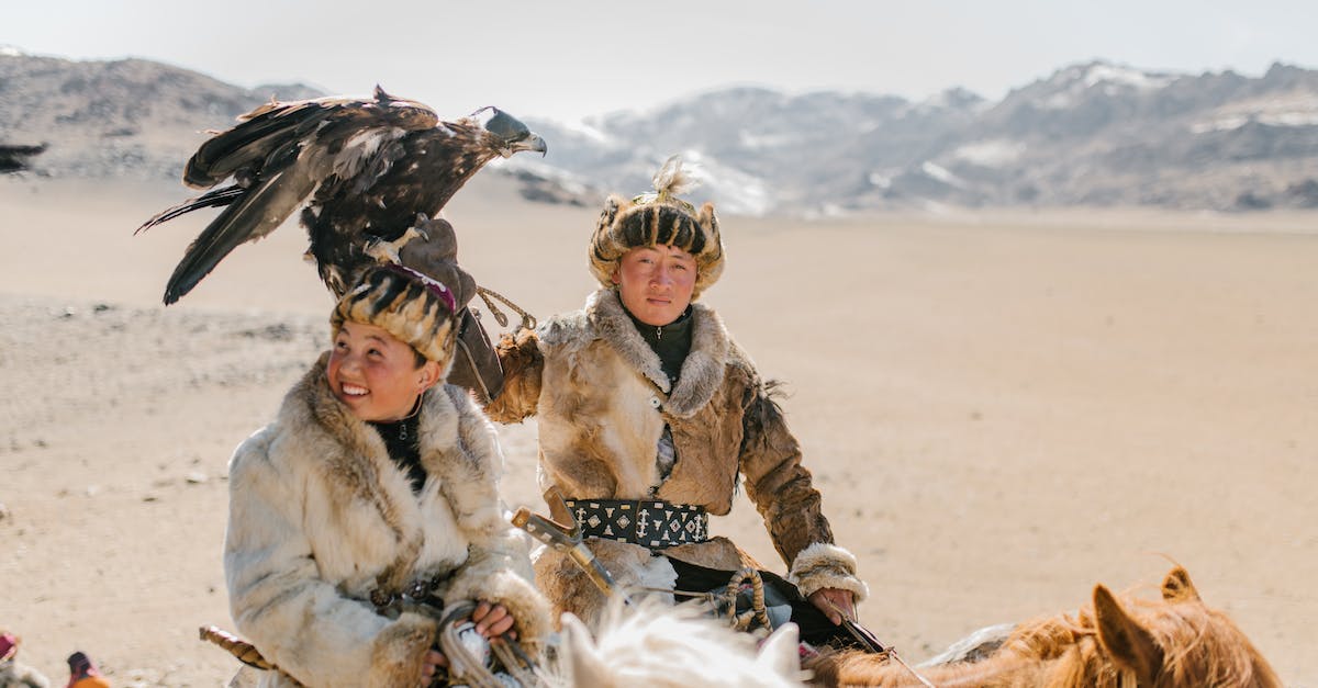 Hunting or normal spears for hunting low level creatures - Positive Mongolian eagle hunters riding horses on mountainous terrain Hunting or normal spears for hunting low level creatures - Positive Mongolian eagle hunters riding horses on mountainous terrain