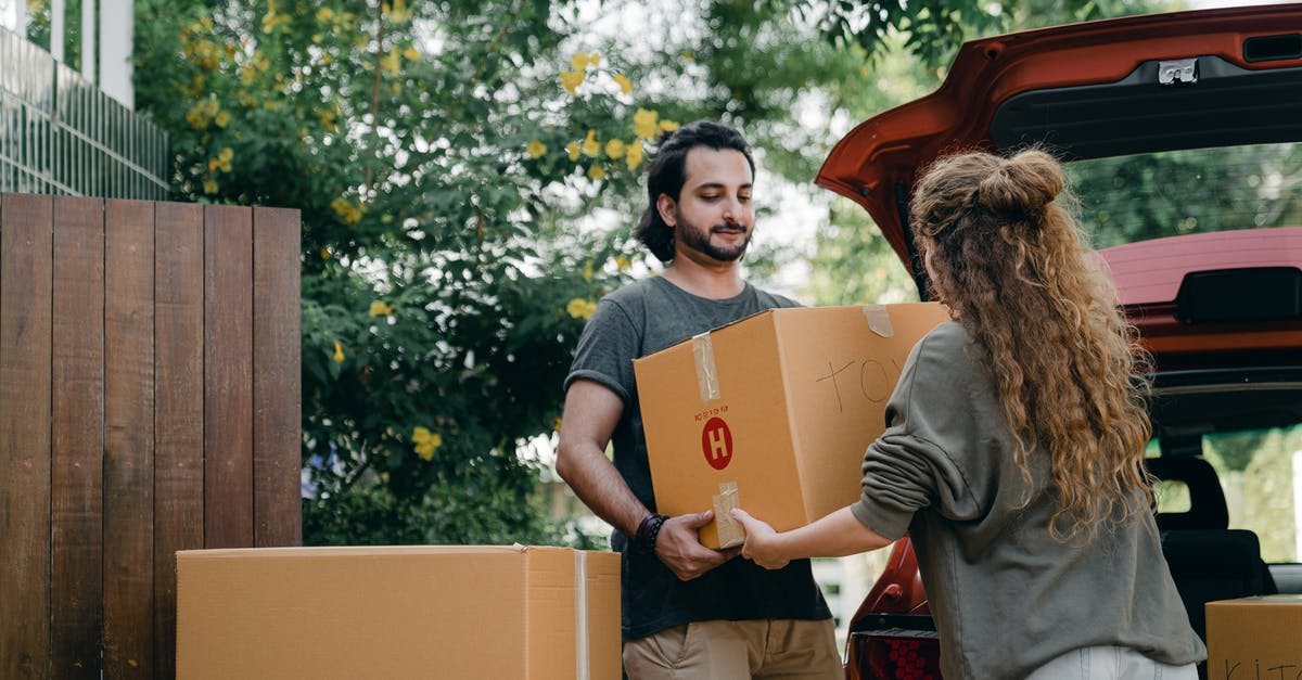 I'm stuck in one place and can't move in Pokémon Go - Boyfriend and girlfriend in casual wear helping each other with unpacking car while moving in together on sunny summer day
