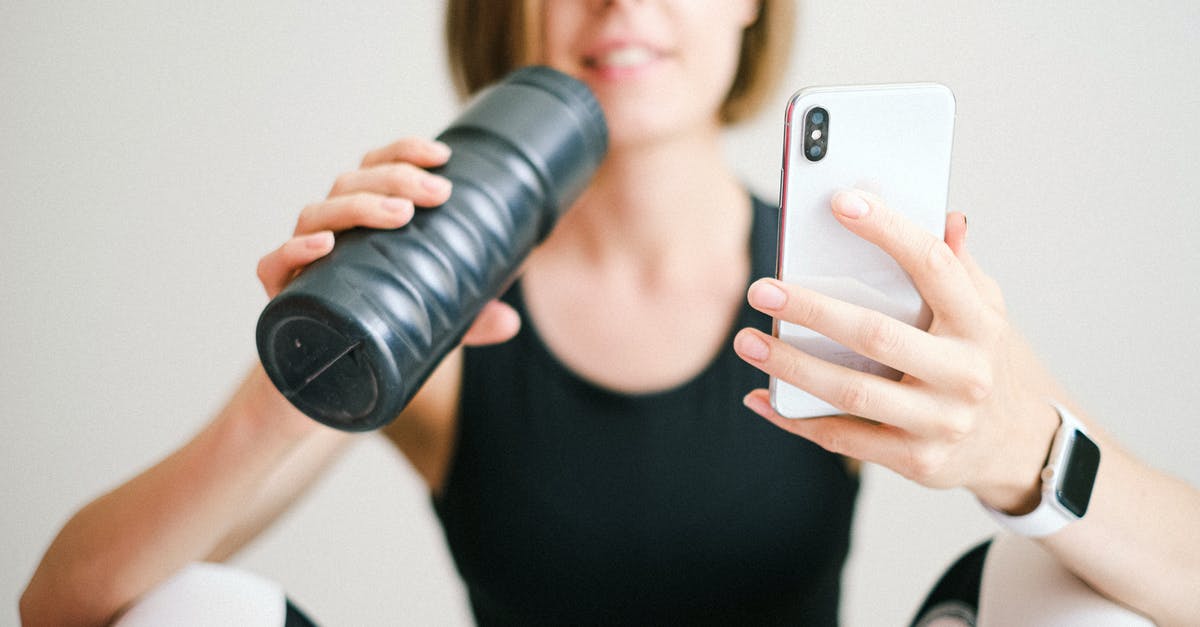 I bought a Velum without a hangar in GTA Online - Photo of Woman Holding White Smartphone and Sports Bottle