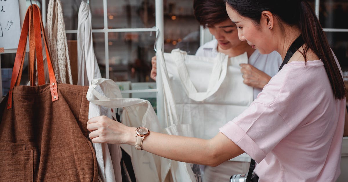 I can't choose my characters while LAN with my friend in DST - Trendy young Asian women choosing cotton bags in fashion boutique I can't choose my characters while LAN with my friend in DST - Trendy young Asian women choosing cotton bags in fashion boutique