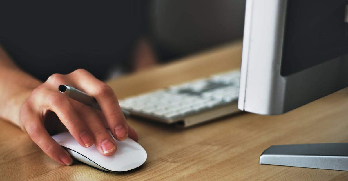 I can't click left click and back thumb button at the same time - Person Holding Apple Magic Mouse