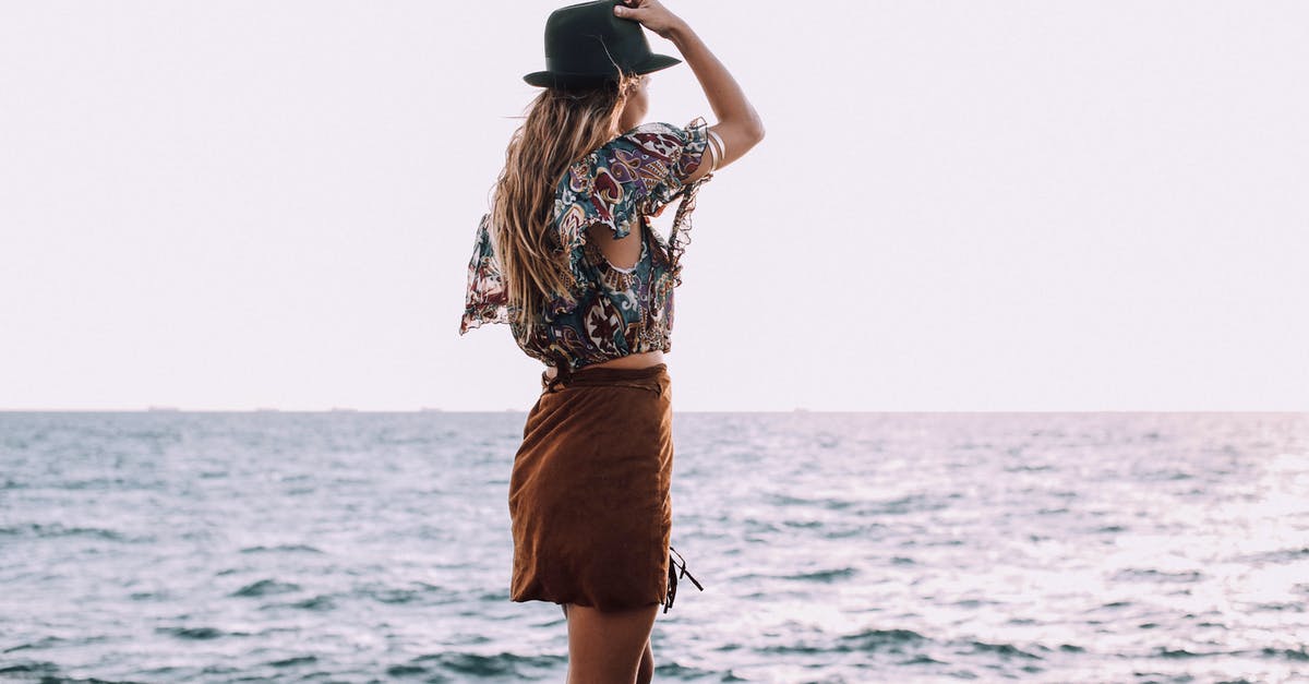 I can't find the Wind Stone - Back view of anonymous female with hand on head in stylish outfit standing on coast and admiring rippling sea I can't find the Wind Stone - Back view of anonymous female with hand on head in stylish outfit standing on coast and admiring rippling sea