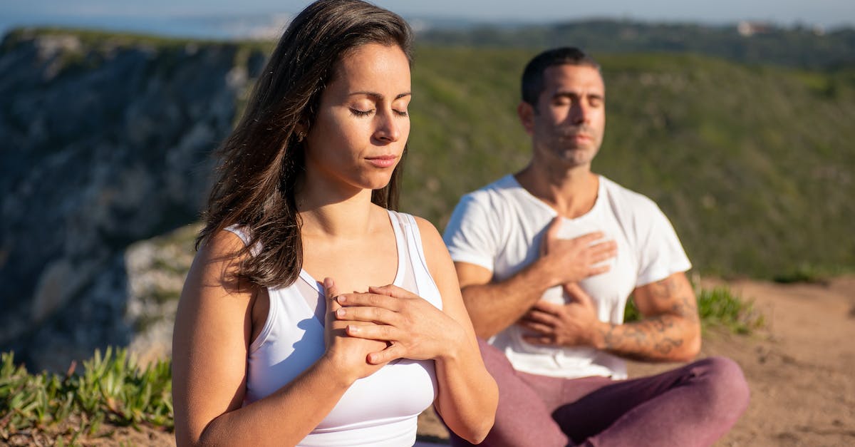 I can't meditate! - Woman and Man Doing Yoga Pose on Mountain Area