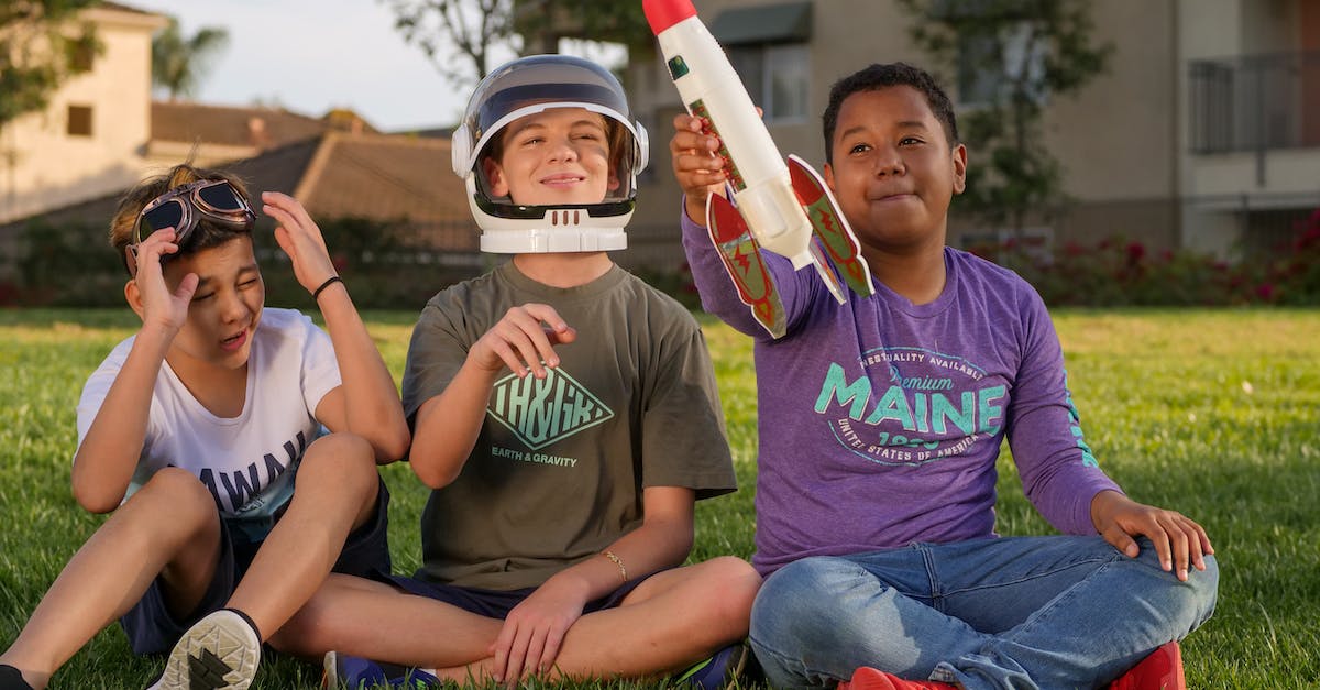 I can't perform science experiments but retrieving space crafts - 2 Boys Sitting on Green Grass Field I can't perform science experiments but retrieving space crafts - 2 Boys Sitting on Green Grass Field