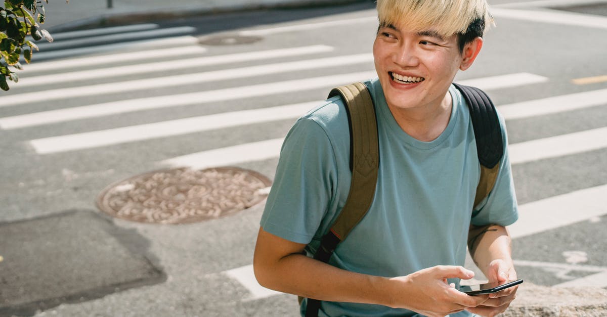 I can't see messages of enemy players in chat (War Thunder) - Cheerful Asian male with trendy hairstyle texting message on mobile phone and looking away on street with pedestrian cross I can't see messages of enemy players in chat (War Thunder) - Cheerful Asian male with trendy hairstyle texting message on mobile phone and looking away on street with pedestrian cross