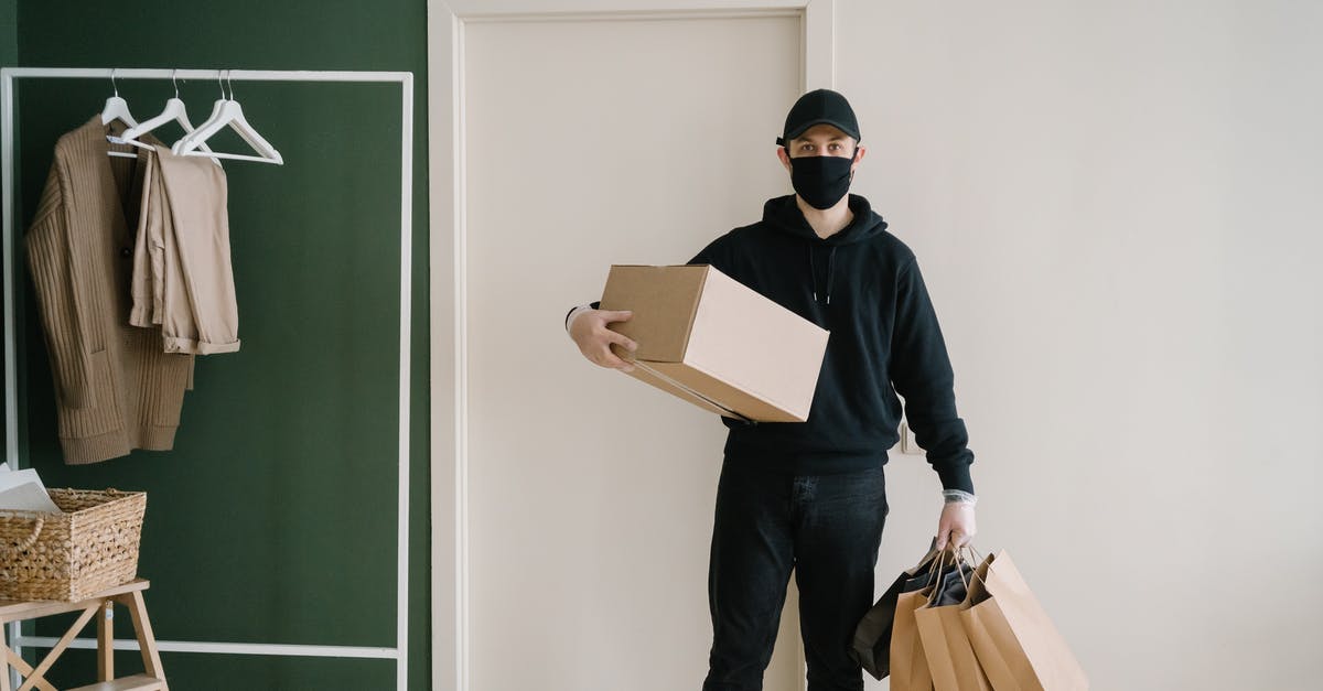 I cant see any pokemons in the nearby box [duplicate] - Man in Black Long Sleeve Shirt Holding Brown Cardboard Box