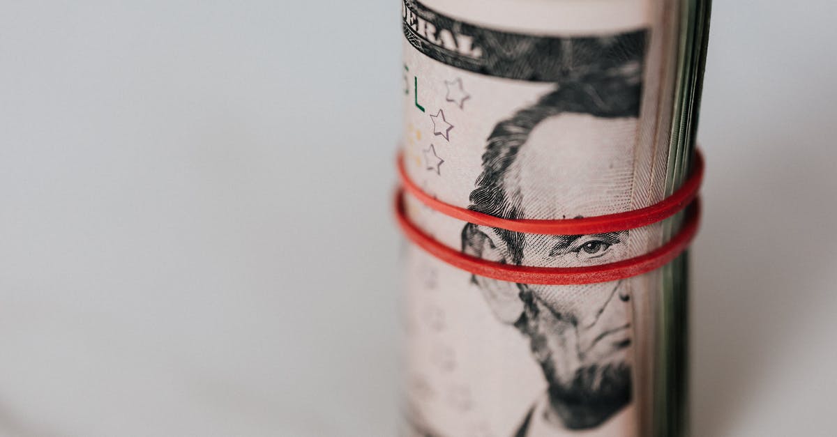 I hacked a bunch of peoples' bank accounts, what can I spend the money on? - Roll of american dollars tightened with red band I hacked a bunch of peoples' bank accounts, what can I spend the money on? - Roll of american dollars tightened with red band