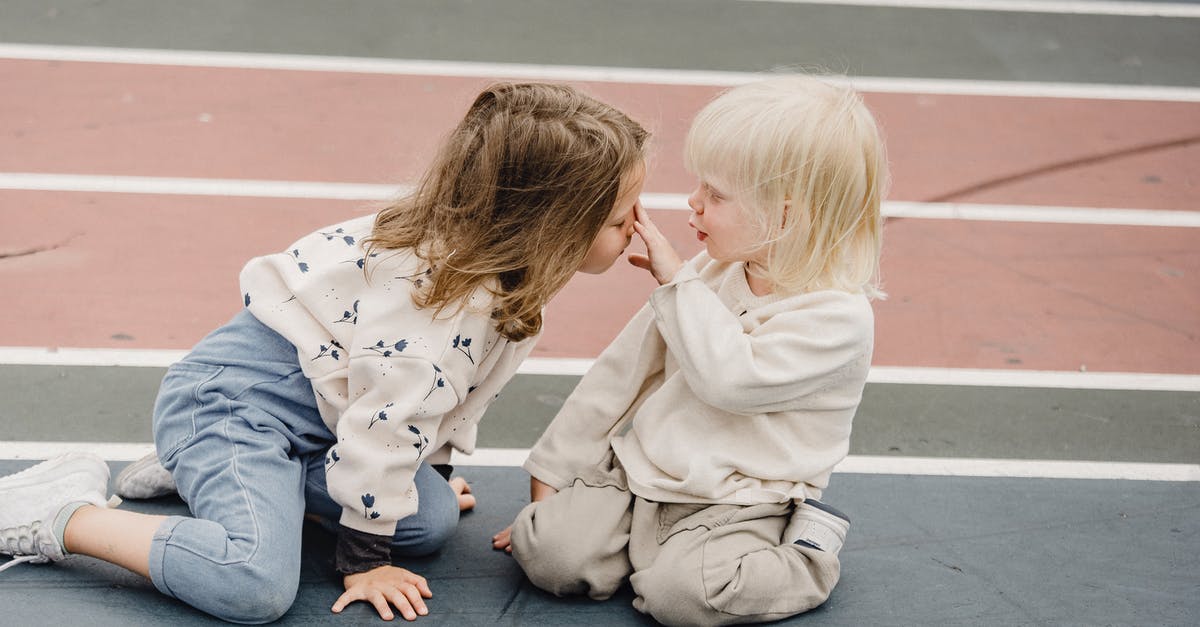 I have an iPod Touch 5th gen. Can I play Pokemon Go? - Side view of cute little boy touching nose of adorable girl while sitting on colorful sports ground together during game