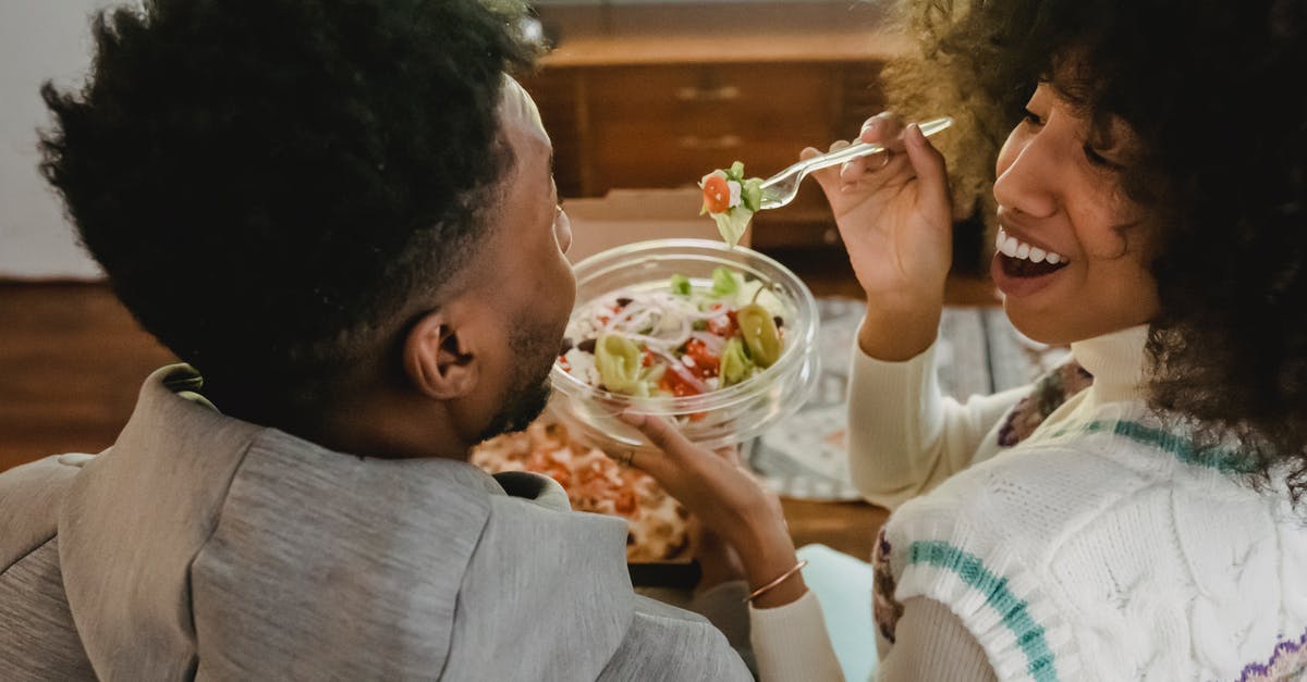 I have Battlefield 3 Limited Edition but it says that I have to buy Back to Karkand? [closed] - Happy young ethnic woman feeding boyfriend with salad while sitting on couch
