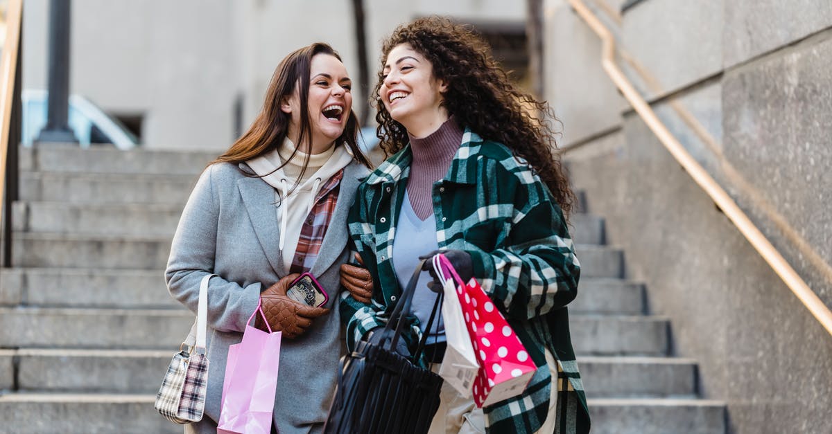 I have my buddy Feebas and have walked 20km with it. Is it too late to evolve? [closed] - Joyful young stylish multiracial female best friends in trendy warm clothes laughing while walking downstairs with shopping bands in hands on city street