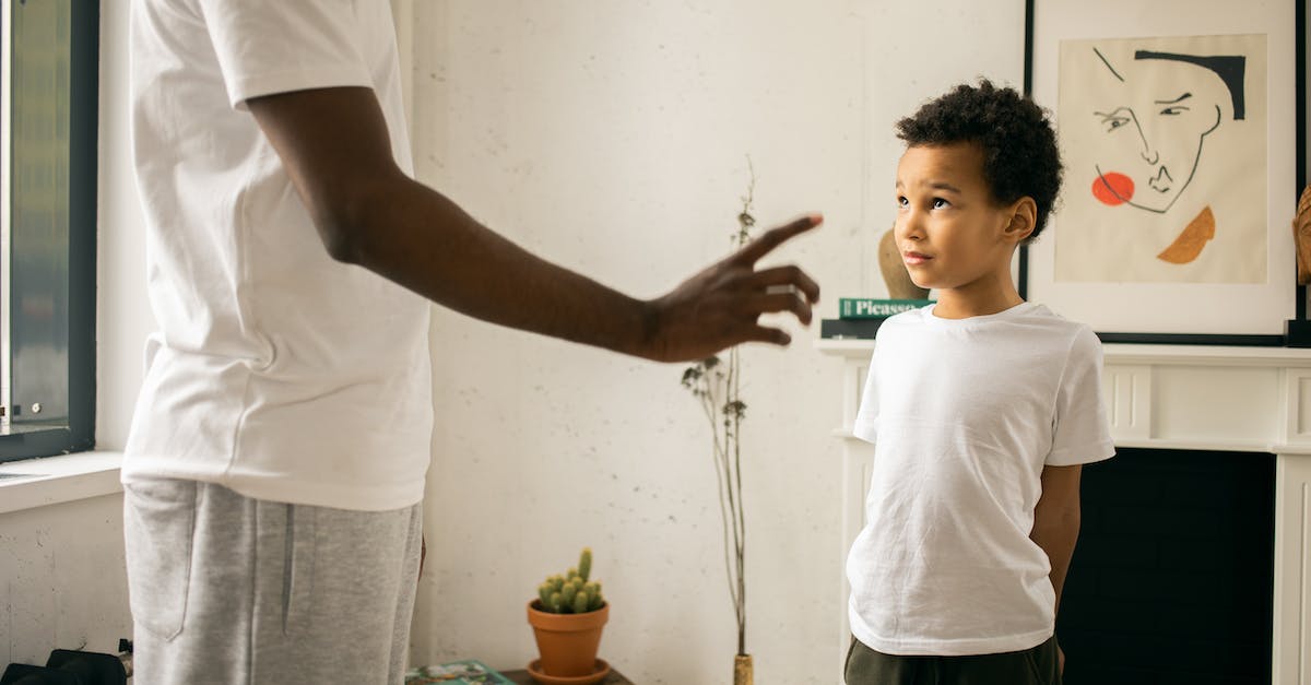 I killed Amata's father and now she won't talk to me - Crop unrecognizable black father disciplining adorable attentive son at home
