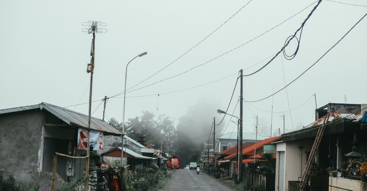 I lost my village and forgot the password - Red and White Concrete Building Near Gray Concrete Road Under White Sky