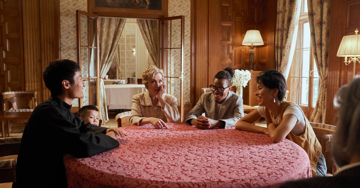 I missed Vincent before talking to Sepiroth in the Shinra Mansion. Can I still recruit him? - Multiracial Family Sitting At Table and Talking with Smile on Faces