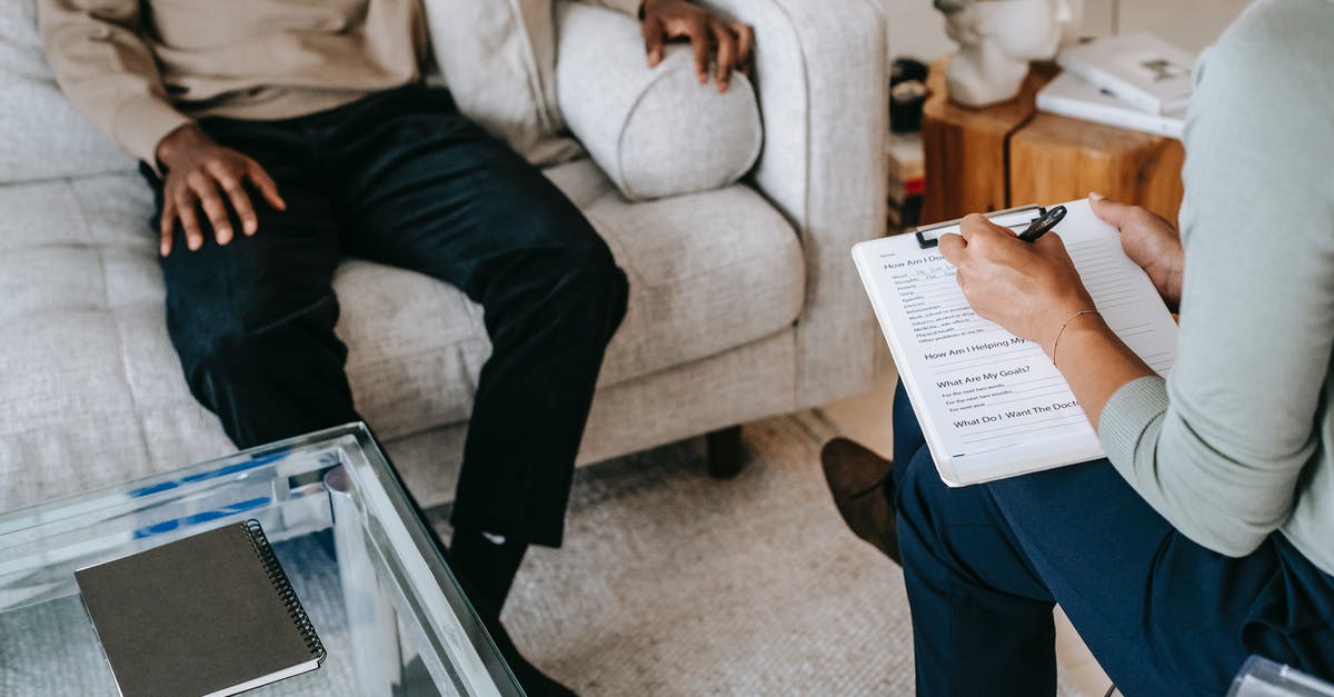 I need some help with this question - From above crop African American male in casual clothes sitting on comfy couch and answering professional female consultant questions in modern psychotherapy office I need some help with this question - From above crop African American male in casual clothes sitting on comfy couch and answering professional female consultant questions in modern psychotherapy office