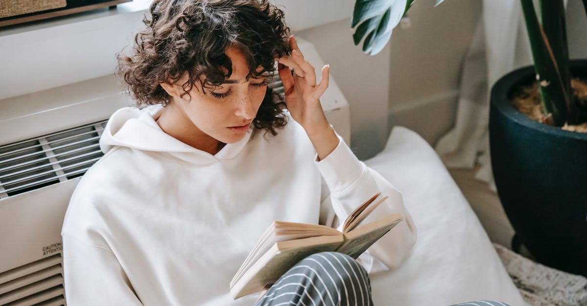 I think i have a soft ban? [duplicate] - Thoughtful female attentively reading book at home
