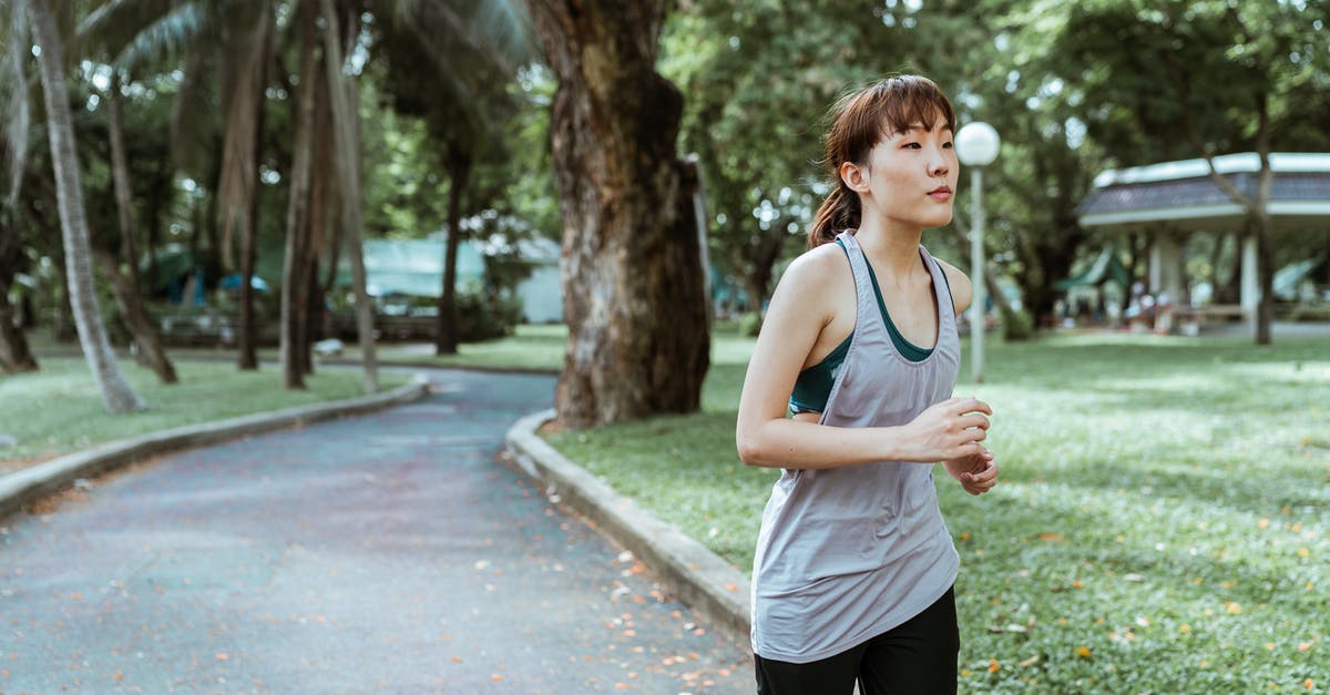 I think I made a mistake while doing a Pacifist run - Pensive Asian sportswoman jogging on pavement in park in daylight I think I made a mistake while doing a Pacifist run - Pensive Asian sportswoman jogging on pavement in park in daylight