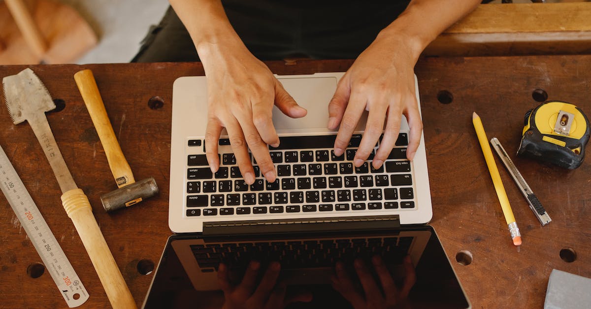 I use an Azerty keyboard. How can I handle keybindings easily? - Faceless artisan typing on laptop in workshop