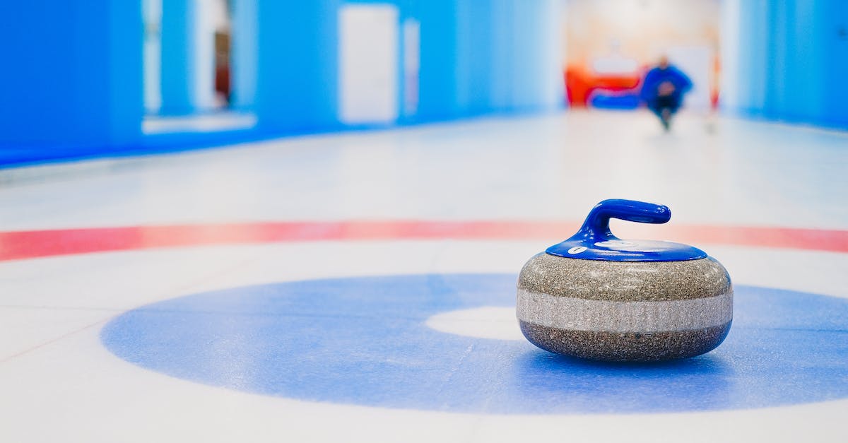 Ice form shout? - Curling stone placed in house on ice rink Ice form shout? - Curling stone placed in house on ice rink