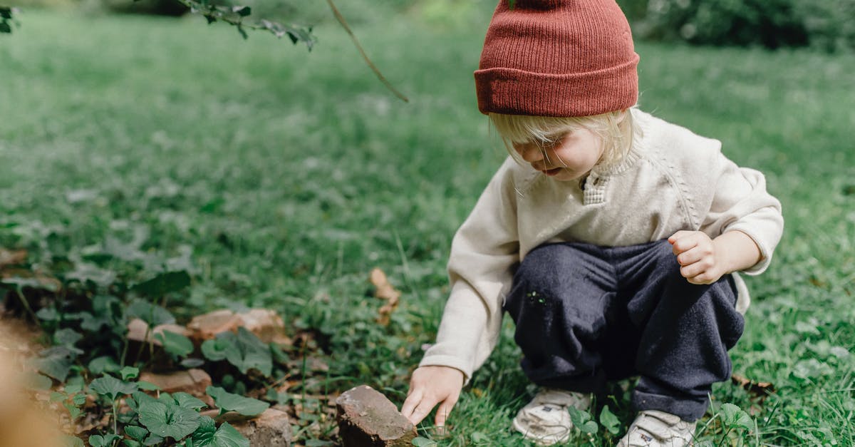 Identification of side-scrolling game - Interested little boy exploring stone Identification of side-scrolling game - Interested little boy exploring stone