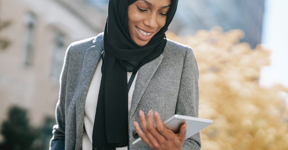 Identify building assets in-game - Black woman in hijab browsing tablet